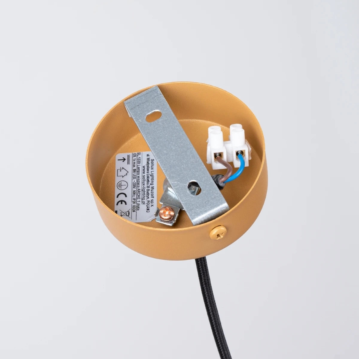 Anschlussdetail der Pendelleuchte CORA 1 in Gold – Metall-Deckenhalterung mit Befestigungsbügel und elektrischer Verdrahtung.